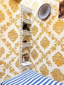 a wall with a mirror and a clock on a wall at Chez Hasnae Studio - Heart of Medina, Close to Sea in Tangier