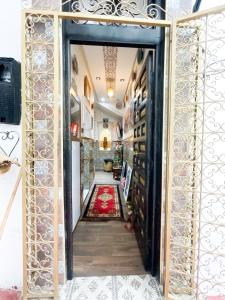 an open door to a room with a red rug at Chez Hasnae Studio - Heart of Medina, Close to Sea in Tangier