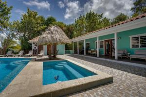a villa with a swimming pool and a house at 6-Guest Beachfront Oasis w Private Pool in Maya Beach