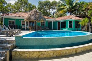 a swimming pool in front of a house at 6-Guest Beachfront Oasis w Private Pool in Maya Beach +58 photos