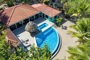 an aerial view of a house with a swimming pool at 6-Guest Beachfront Oasis w Private Pool in Maya Beach
