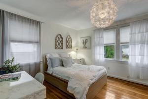 ein Schlafzimmer mit einem großen Bett und einem Kronleuchter in der Unterkunft Happy Coastal Cottage for 6 in Jacksonville