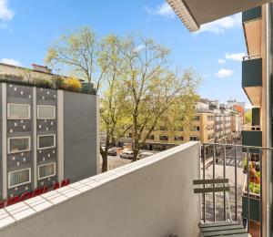 a balcony with a view of a street and buildings at Smart City Apartment in Bestlage! self check-in, Neu! in Cologne
