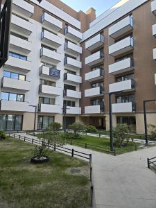 an apartment building with a park in front of it at Reda City EnergyApart in Szczecin