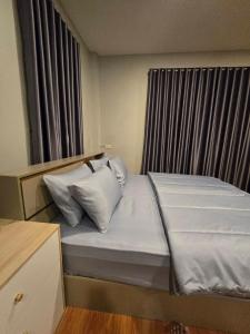 a bed with two pillows on it in a room at Chaba 4 family in Nakhon Nayok +10 photos