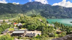 an aerial view of a resort with a lake and mountains at Trolltunga Camping in Odda