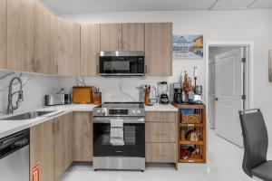 a kitchen with wooden cabinets and a stove top oven at Charming 1 Bedroom Apartment in Homestead +22 photos