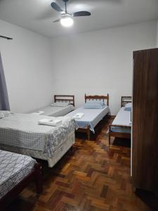 Postel nebo postele na pokoji v ubytování Casa familiar e espaçosa em Aparecida SP, com 3 quartos