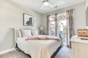 a white bedroom with a bed and a window at Surf City House about 400 Ft Walk to Beach with Decks! in Surf City