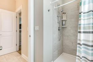a bathroom with a shower with a shower curtain at Surf City House about 400 Ft Walk to Beach with Decks! in Surf City +35 photos