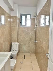 a bathroom with a shower and a toilet at Spacious Lovely Apartment in Sarandë +52 photos