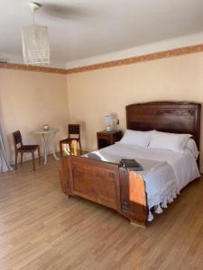 a bedroom with a large wooden bed in a room at Maison de vacances in Nadaillac