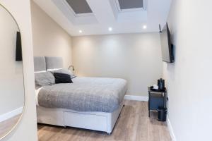 a bedroom with a bed and a mirror at The Bear inn in Llantrisant