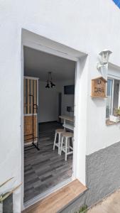 an open door to a patio with a table and a table at La Cabaña Estudio pequeño in Fasnia