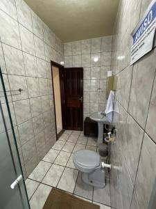 a bathroom with a toilet and a sink at Encanto do Beija-flor in Angra dos Reis +23 photos
