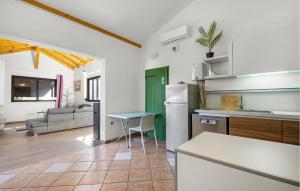 a kitchen with a refrigerator and a table in a room at 2 Bedroom Nice Home In Jezera in Jezera