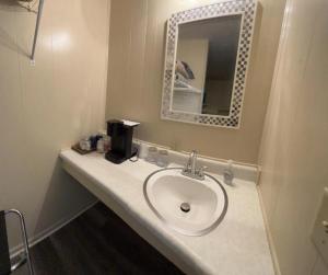 a bathroom with a sink and a mirror at Harper Motel in Harper