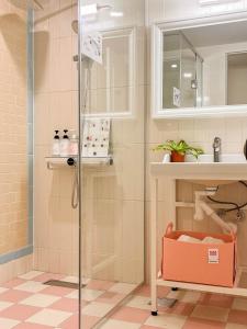 a bathroom with a shower and a sink at Roots House in Busan +38 photos