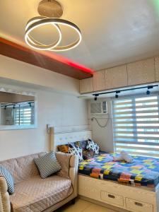 a small bedroom with a bed and a couch at Avida Towers Riala Tower inside IT Park Cebu City in Cebu City