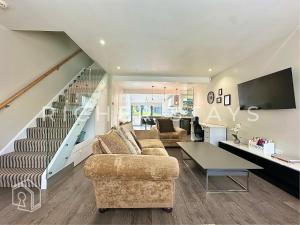 a living room with a couch and a table at Premium 3BR House, French Doors and Private Garden in Borehamwood