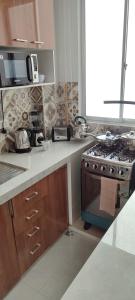 a kitchen with a stove and a counter top at Nuevo y moderno departamento in Sucre
