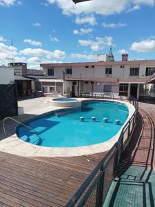 a swimming pool on the roof of a building at Hotel Nuevo Enzo in Villa Carlos Paz