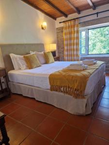 a bedroom with a large bed in a room at Casa de Sao Miguel Douro in Armamar