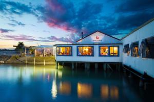 a building sitting on top of a body of water at Apple Valley West - Mahana in Mahana