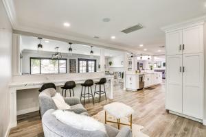 a kitchen and living room with a couch and chairs at Pool, Spa and City Views Luxe Home in San Diego! in San Diego