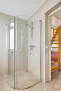 a glass shower in a bathroom with a staircase at Huisje 118 bungalowpark Simpelveld in Simpelveld +57 photos