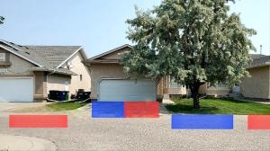 a garage with red blue and red squares in front of a house at Saskatoon Lashyn Cove Homestay in Saskatoon