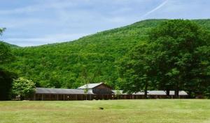 a barn in front of a green hill at Aerie Inn of Vermont in East Dorset