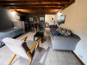 a living room with two couches and a table at Villa La Angostura in Villa La Angostura