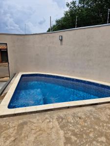 a swimming pool in front of a wall at Espaço Run in Bálsamo