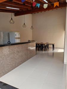 a kitchen and dining room with a counter and tables at Espaço Run in Bálsamo