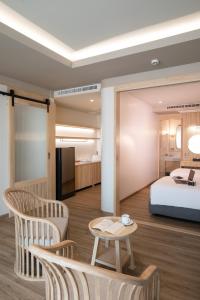 a hotel room with a bed and a table and chairs at Khum Phucome Hotel -SHA Extra Plus in Chiang Mai +141 photos