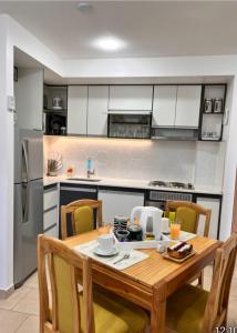 a kitchen with a wooden table and chairs at Ushuaia Extremo Sur in Ushuaia