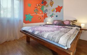 a bedroom with a bed with butterflies on the wall at 1 Bedroom Pet Friendly Home In Lovran in Lovran