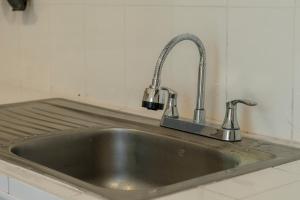 a stainless steel sink in a kitchen at Habitación triple confort - Casa Esmeralda in San José +50 photos