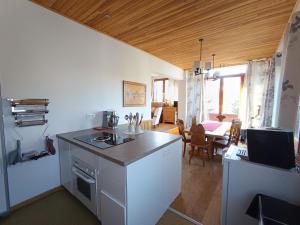 a kitchen with a stove and a counter top at Chalet spacieux au soleil près des pistes, idéal pour 9 personnes - FR-1-445-219 in Montgenèvre +8 photos