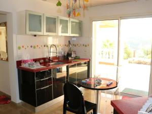 a kitchen with a counter and a sink and a table at Villa de Maître 6 Chambres avec Piscine et Jacuzzi - FR-1-768-119 in Roquebrune-sur-Argens