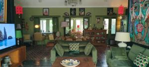 a living room with a couch and a tv at Rumah TONTON, Charming cottage in a pop-art atmosphere in Kubutambahan