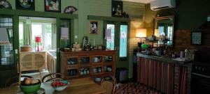 a kitchen with a table and a dining room at Rumah TONTON, Charming cottage in a pop-art atmosphere in Kubutambahan