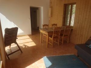 a dining room with a wooden table and chairs at Gîte le plan in Saint-Martin-de-Lansuscle +7 photos