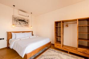 a bedroom with a bed and a book shelf at Brand-New Loft Balangan Village in Badung