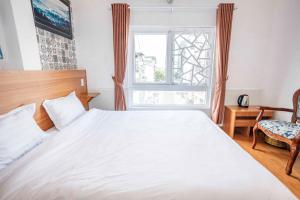 Postel nebo postele na pokoji v ubytování Thanh Anh 2 Hotel - Gần Chợ Đêm Đà Lạt
