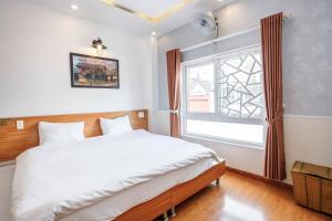 Postel nebo postele na pokoji v ubytování Thanh Anh 2 Hotel - Gần Chợ Đêm Đà Lạt
