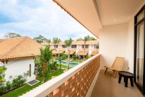 a balcony with a view of the pool and resort at Brand-New Loft Balangan Village in Badung +38 photos