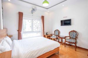 Postel nebo postele na pokoji v ubytování Thanh Anh 2 Hotel - Gần Chợ Đêm Đà Lạt