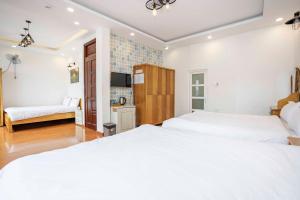Postel nebo postele na pokoji v ubytování Thanh Anh 2 Hotel - Gần Chợ Đêm Đà Lạt